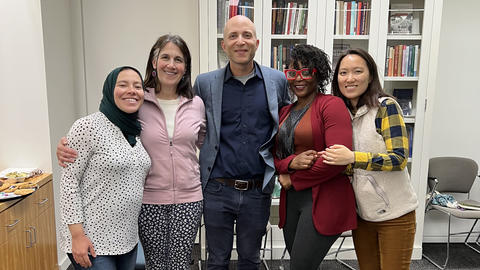 Three graduate students pose with Weatherhead director and staff.