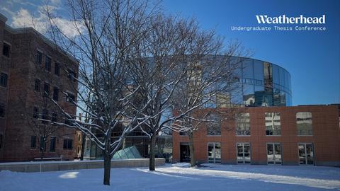 The CGIS Knafel building and yard under a blue sky in winter, with snow on the ground. 