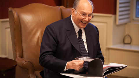Image of His Highness the Aga Khan with photo album