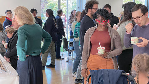 People milling around at the Fisher Family Commons ice cream social.