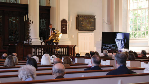 Attendees sitting in pews in memorial church during the memorial service for Herbert C. Kelman