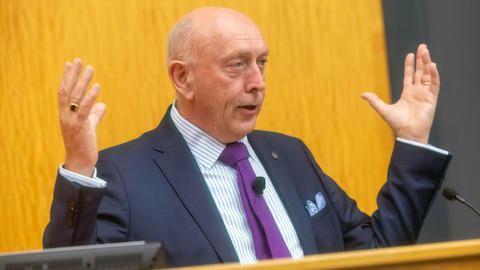 Peter Sheridan gesticulates from the podium.