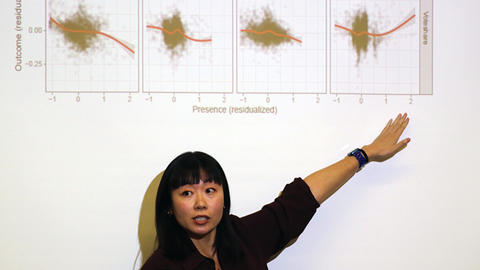 Yang-Yang Zhou points to a slide at her Weatherhead Spotlight presentation