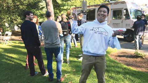 Harvard student Jonathan Zhang poses in front of the waffle truck