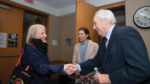 Image of Kathryn Sikkink shaking David Manshel's hand