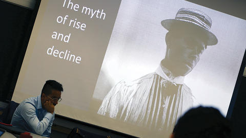 Image of Israel G. Solares listening to fellow speaker at the Weatherhead Forum