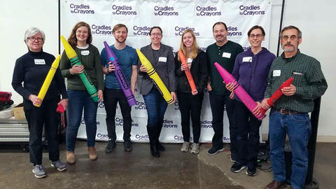 Image of WCFIA staff volunteering at Cradles to Crayons