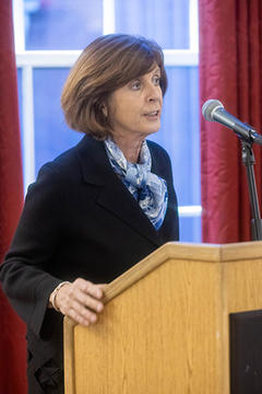 Dame Louise Richardson speaks at a podium.