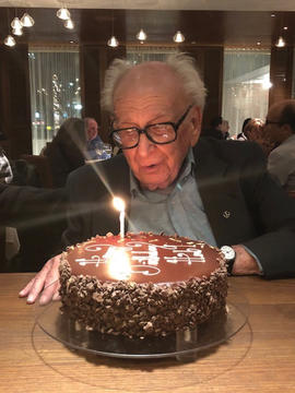 Herb Kelman blows out candles at his 91st birthday celebration