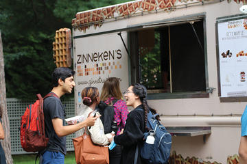 Students chat while waiting in line for waffles at the waffle truck