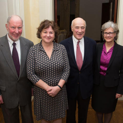 Four past directors stand next to each other, smiling.