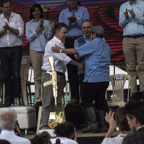 Colombian president Juan Manuel Santos shakes hands with Rodrigo Londoño, alias “ Timochenko ”, top commander of the FARC insurgent army, at a celebration for the completion of the FARC’s disarmament, June 27, 2017.