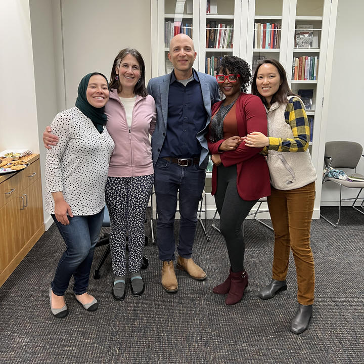 Three graduate students pose with Weatherhead director and staff.