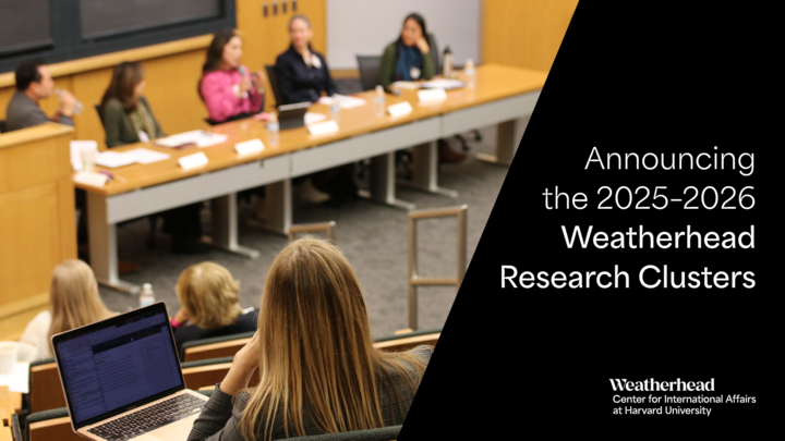 Graphic shows a photo of a woman in the audience with a laptop watching a five-person panel discussion, along with a black box with the following words overlaid in white: "Announcing the 2025-2026 Weatherhead Research Clusters."
