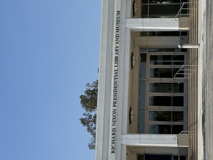The exterior of the Nixon Presidential Library and Museum on a sunny day with a blue sky in the background.