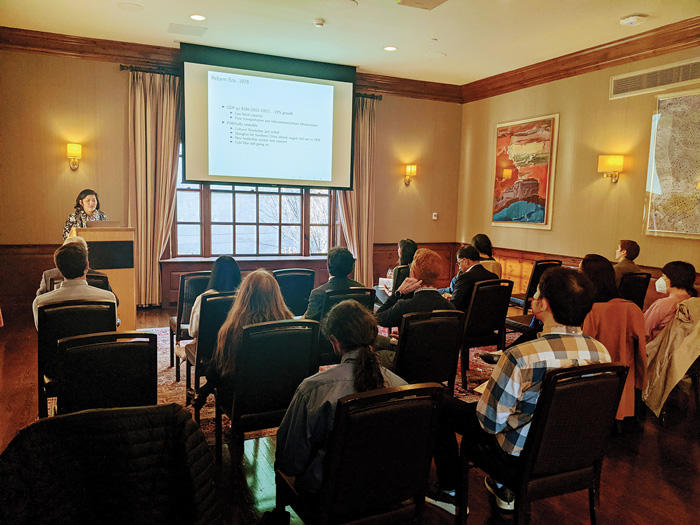 Harvard Academy affiliates listening to speaker present a talk