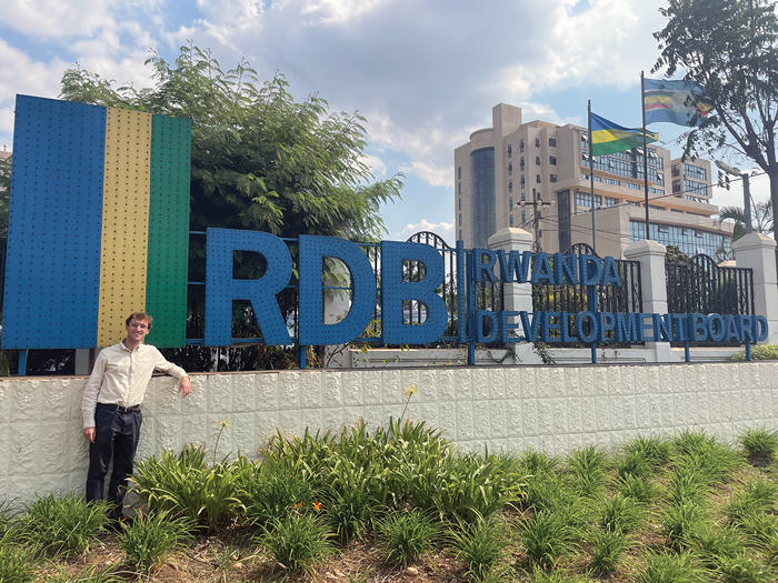 Garrett O'Brien poses in front of Rwandan Development Board building.
