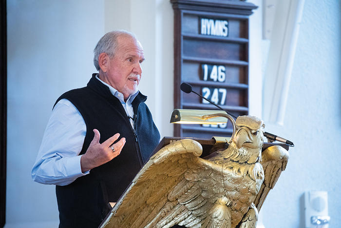 Larry Brilliant gives opening remarks at the podium at Memorial Church