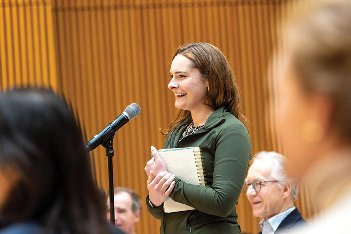 Audience member standing at the microphone, asking Gina McCarthy a question during the Q&A.