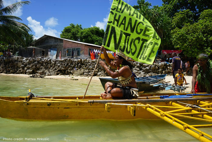 Image of Kiribas climate activist on a boat