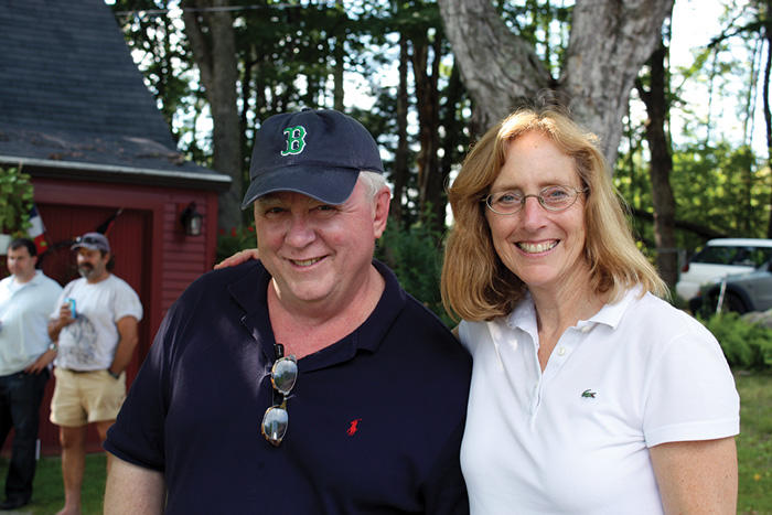 Former staff member Tom Murphy shares a hug with Kathy Molony at a staff outing in 2008