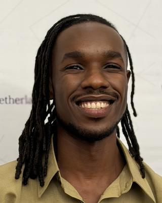 Headshot of Alpha Imani. 