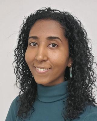 Headshot of Yousra Neberai.