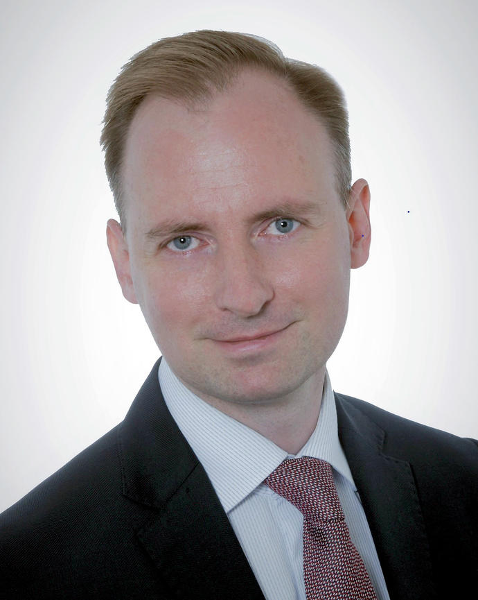 Headshot of Michał Chabros.