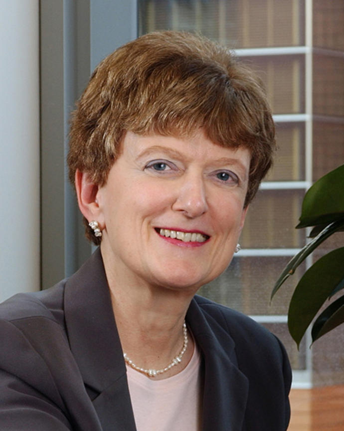 Woman with short hair smiling.