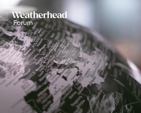 Close-up of a black and white globe with the words "Weatherhead Forum" in white.