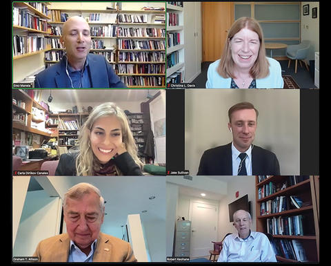 Six people participate in a virtual meeting, each in individual locations, appearing in separate windows with bookshelves and office backgrounds visible behind them.