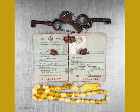 Found objects like old keys, passport, and necklace all against a gold background. 