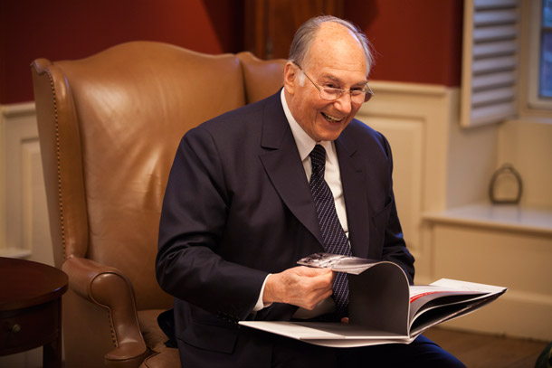 Image of His Highness the Aga Khan with photo album