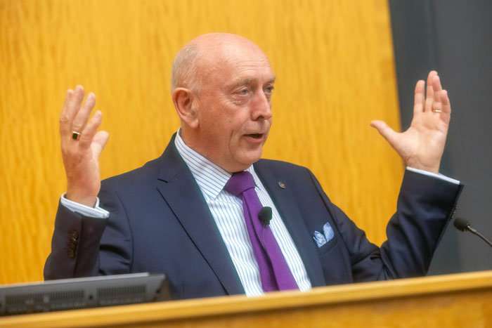 Peter Sheridan gesticulates from the podium.