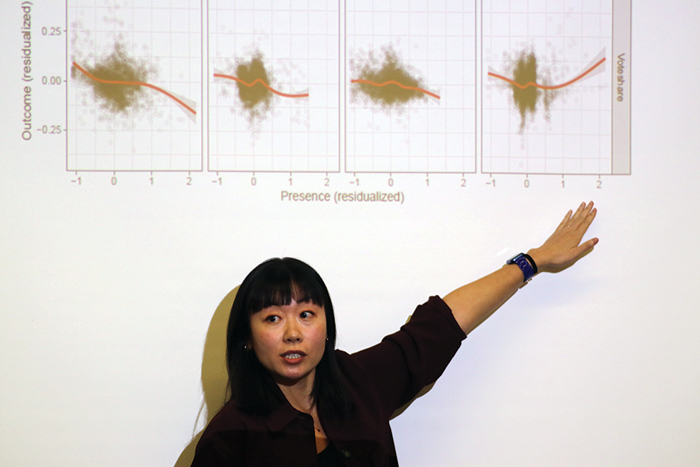 Yang-Yang Zhou points to a slide at her Weatherhead Spotlight presentation