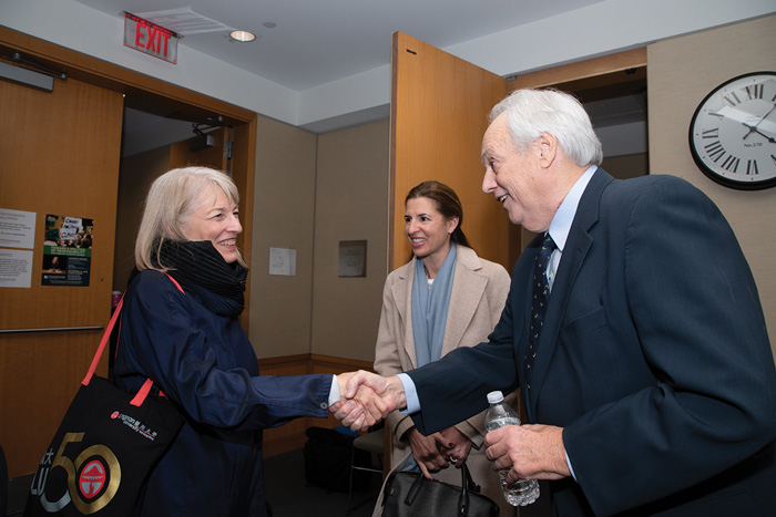 Image of Kathryn Sikkink shaking David Manshel's hand