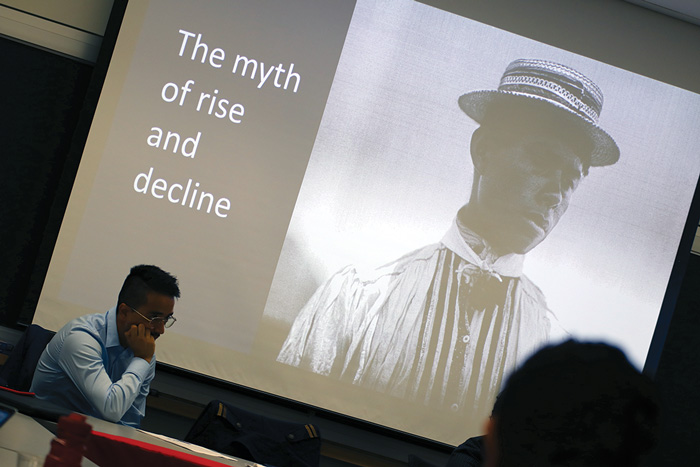 Image of Israel G. Solares listening to fellow speaker at the Weatherhead Forum