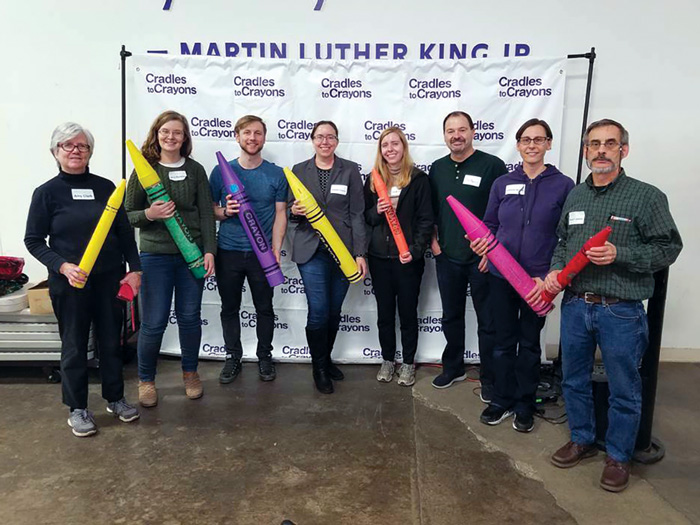 Image of WCFIA staff volunteering at Cradles to Crayons